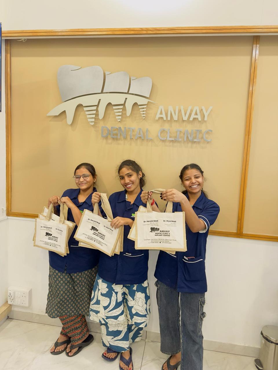Clinic staff holding branded jute bags made by KAIRA.ADDON
