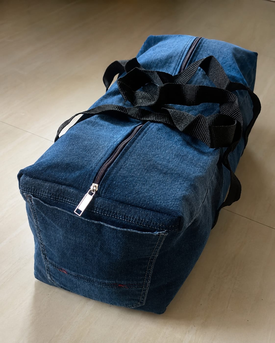 Blue upcycled denim duffle bag made by KAIRA.ADDON
